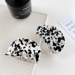 Set of two black and white marble pattern hair claws with elegant cow print design
