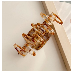 Close-up of a large tortoiseshell hair claw clip with hollowed-out acetate design