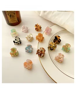 Mini acetic acid hair claws in tortoise shell and marble patterns on white plate