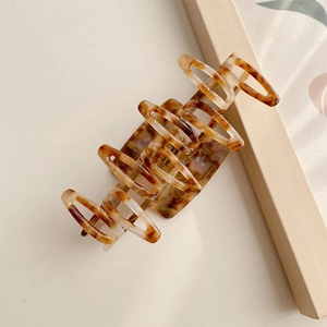 Large amber tortoiseshell hair claw clip with cutout design for women hair styling
