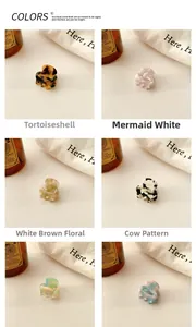 Detail of mini acetate hair claws in tortoise, marble, and floral patterns with fabric props