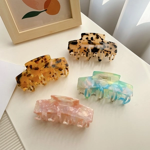 Set of four large acetate hair claw clips in tortoise and marble patterns for women