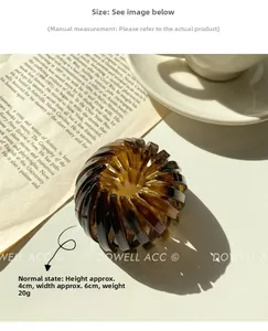 Amber tortoiseshell bird nest hair clip claw for ponytail styling on a white surface