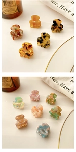 Detail of mini acetate hair claws showing marble texture and elegant small spring mechanism
