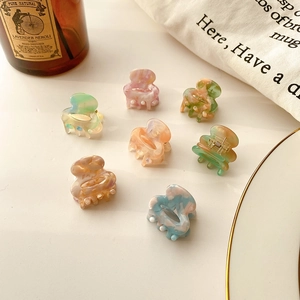 Set of 7 mini acetate hair claws in pastel marble colors for elegant styling