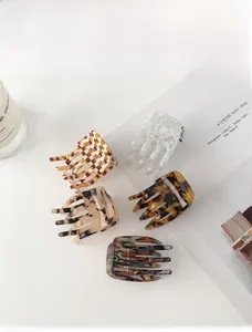 Flat lay of retro acetate claw clips in checkered, leopard, and marble patterns