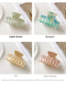 Close-up of marble pattern acetate hair claws in green, blue, white, and purple colors