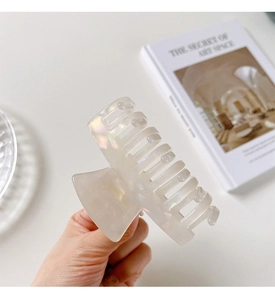 Detail of elegant pearlescent acetate hair claw clip with strong grip for styling
