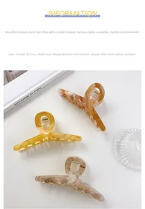 Detailed view of 10.5cm large acetate hair claw clips in amber and marble textures