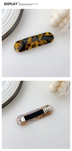 Detailed view of acetic acid hair clip with yellow leopard pattern and metal spring clip
