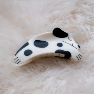 Close-up of sleeping Dalmatian puppy hair claw clip made of glossy acetate material