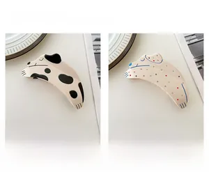 Detail view showing dalmatian and colorful rhinestone dog acetate hair claw clips