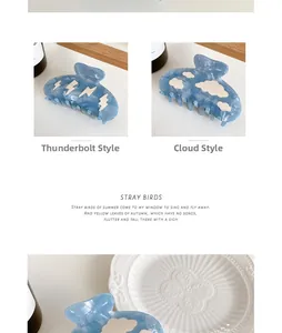 Detail view of blue marble acetate hair claws with cloud and lightning patterns