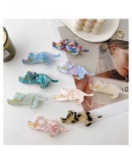Macro detail of 8cm cat hair clips with marble texture and golden line accents
