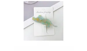 Close-up of a blue cat-shaped hair clip made of acetate on a jewelry display card