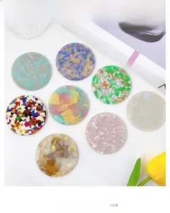 Flat lay of colorful acetic acid handheld mirrors with vintage textures and marbling