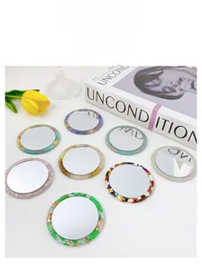 Macro detail of round acetate pocket mirror with retro marble pattern frame and smooth finish