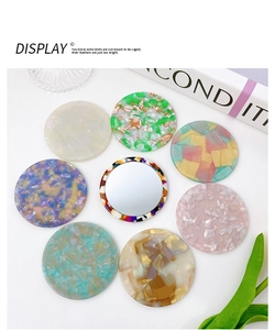 Detailed top view of 8 assorted acetate pocket mirrors in marble and tortoise patterns