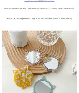 Charming acetate cat-shaped mini mirrors in vibrant colors on a wooden tray