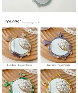 Detail view of portable deer-ear makeup mirrors in marble and floral purple textures
