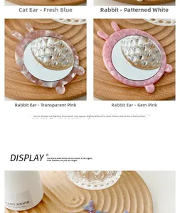 Detailed view of animal-eared mini makeup mirrors in marble acrylic on a wooden tray