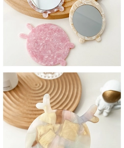 Detail of portable acetate makeup mirrors with cute animal ears and pink marble pattern