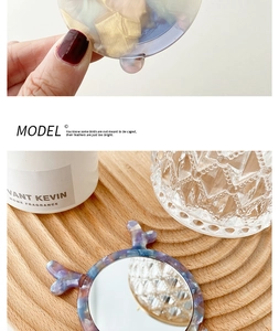 Detail of deer antler acetate handheld makeup mirror with blue marble texture