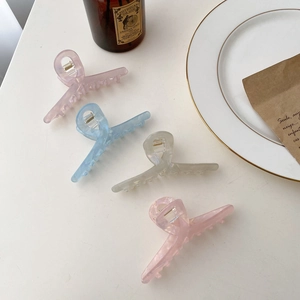 Set of four tortoiseshell acetate hair claws in pastel marble colors with gold metal springs