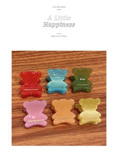 Detail shot of mini bear-shaped hair claws in six colors with gold France lettering
