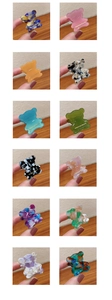 Collage of 12 colors of bear-shaped acetate mini hair clips with gold lettering