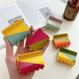 Two-tone acetate hair claw clip with geometric diagonal splicing in vibrant colors