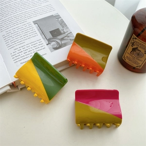 Three-piece set of minimalist acetate hair claws with geometric color block patterns