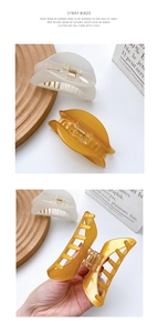 Close-up of large acetate claw clips in cream and amber with golden metal springs
