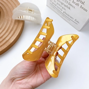 Chic amber and cream acetate hair claw clips for thick hair with golden label