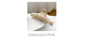 Iridescent pink and green marble acetate hair claw clip with cross-twist design detail