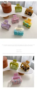 Detail of square acetate hair claw clips in various colors including mint and lilac