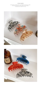 Detail of premium acetate hair claw clips in various elegant patterns and colors