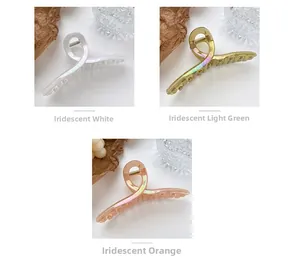 Iridescent resin hair claws in white, light green, and orange with pearlescent finish