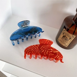 Minimalist large marble texture hair claws in blue and orange colors for women
