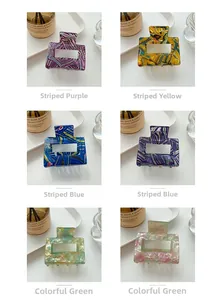 Detail view of square acetate hair claws in six different colorful marble patterns