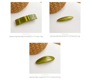 Detailed view of olive green acetate hair clips with cat-eye texture and spring mechanism