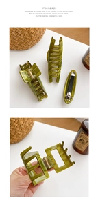 Detail of dark green marble acetate hair claw clip and flat barrette with metal spring