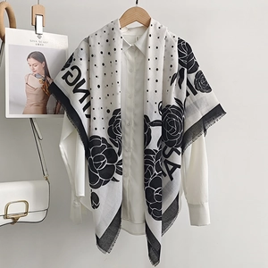 Elegant black and white floral dot printed thin scarf draped on white shirt