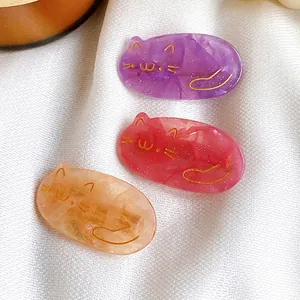 Three cute cat hair clips in purple, magenta, and orange with fine glitter details