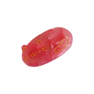 Pink glitter resin cat hair clip with gold facial details on white background