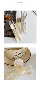 Detail of large marble textured hair claw clips in cream and taupe for thick hair