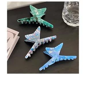 Three-piece set of butterfly-shaped acetate hair claws in marble and solid blue colors