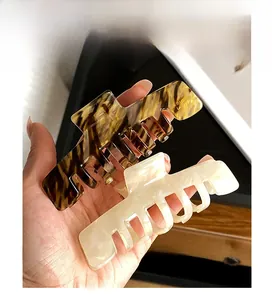 Macro detail of large tortoiseshell and creamy white acetate hair claws for thick hair