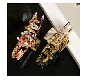 Detail of colorful marbled and amber tortoise shell acetate hair claws with metal spring