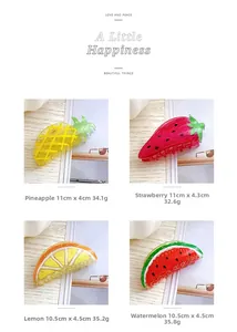 Detail view of large fruit shaped hair claws in strawberry and pineapple acrylic styles